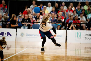 The USA's Eliana Mason winds up for a shot watched by spectators